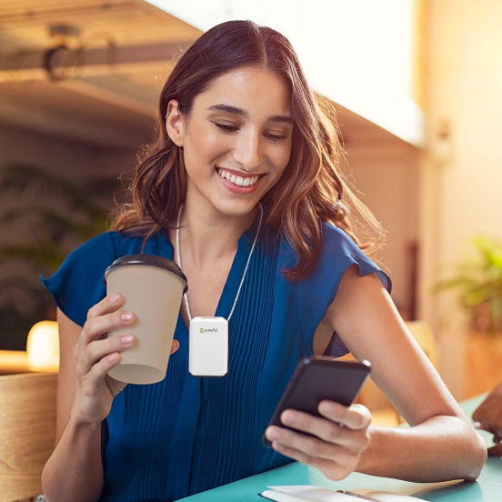 PureAir Solo wearable air puifier on woman while drinking coffee